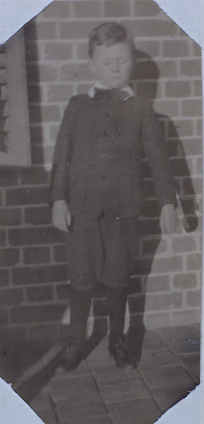 A boy on a homestead verandah, 1