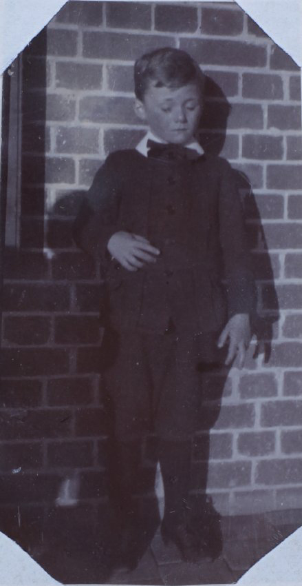 A boy on a homestead verandah, 2