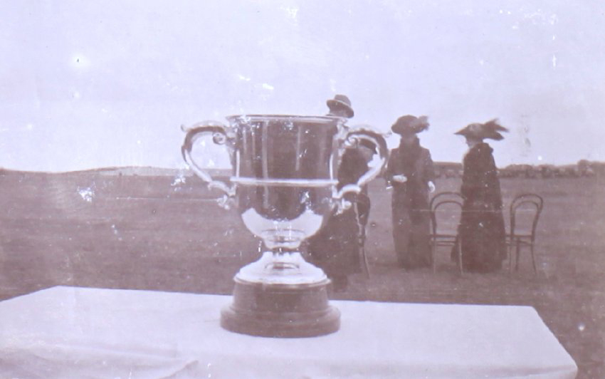 Trophy with unidentified people in the background