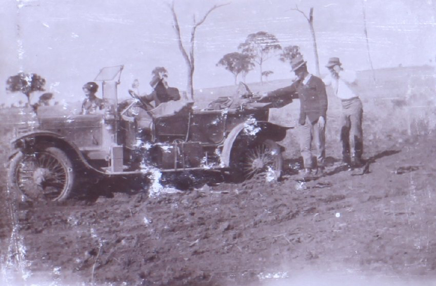 Three men and one woman with a bogged car