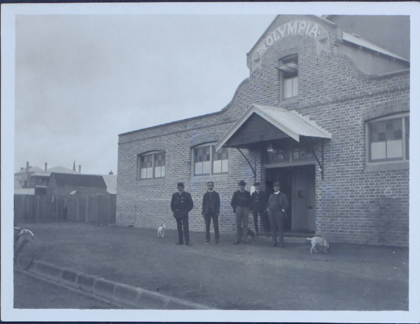 Five gentlemen outside the Olympia skating rink, Armidale, NSW