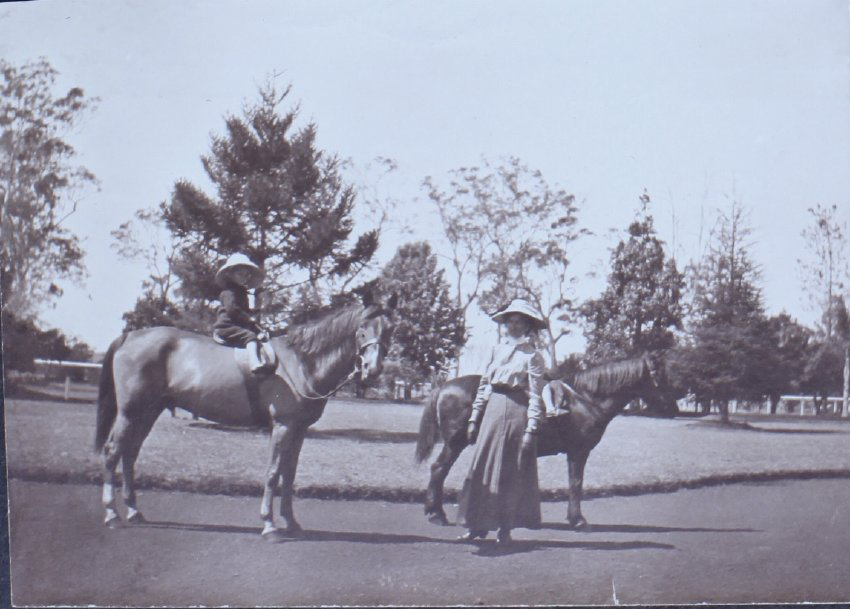 Children on horseback with unidentified woman