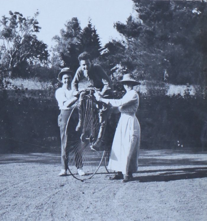 Soldier on pennyfarthing bike with a man and a woman