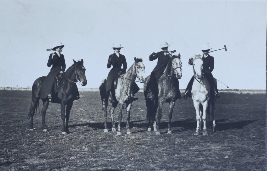 Four women on horseback with polo sticks
