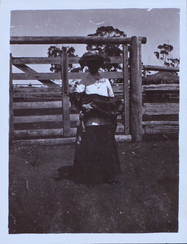 Woman with a foal in her arms