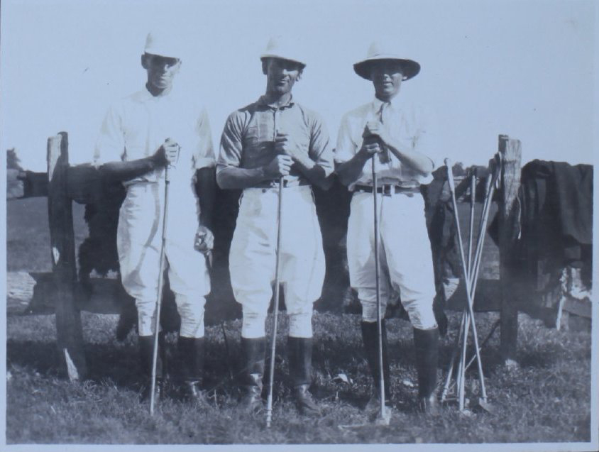 Three men with polo sticks
