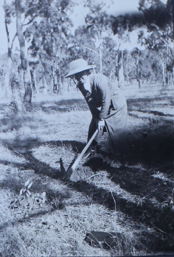 Woman with a pick in the paddock
