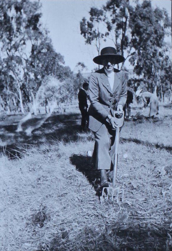 Woman with a digging fork, other in the background