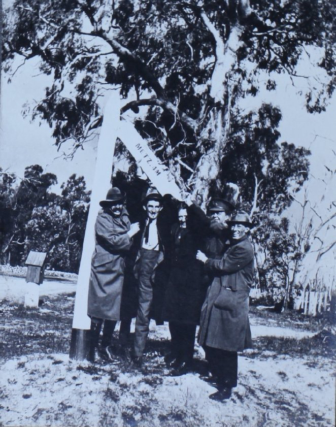 Group of men with the Metz sign, east of Armidale, NSW