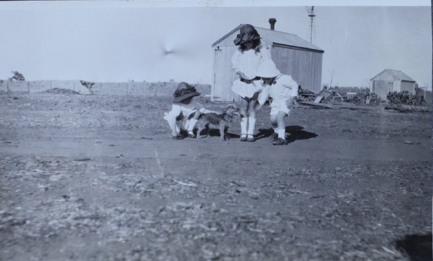 Three children with a pet dog