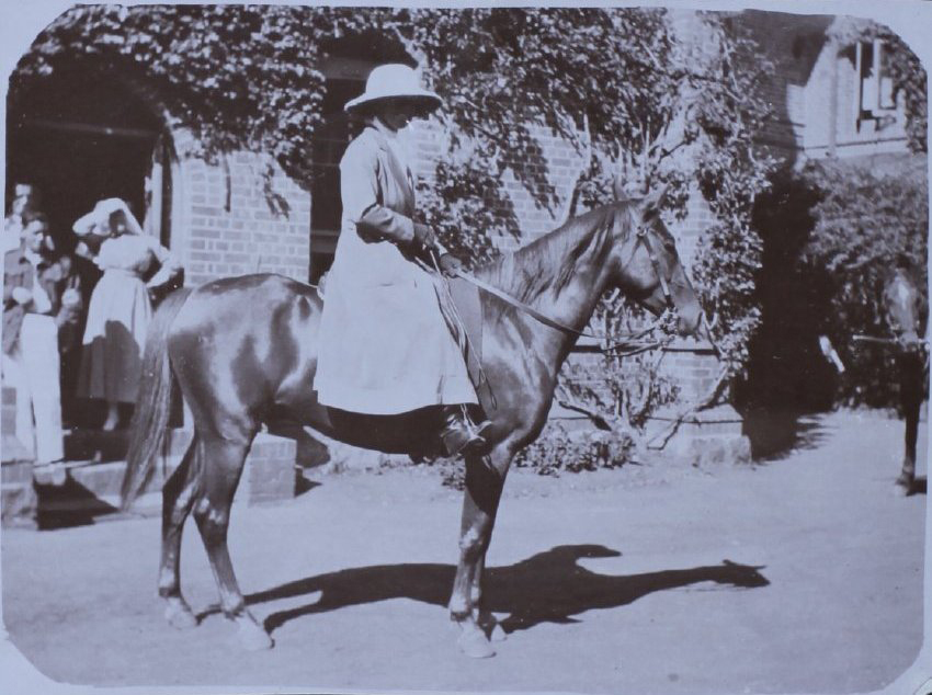 Woman on a horse in front of Booloominbah