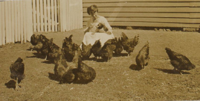 Unidentified woman with chickens