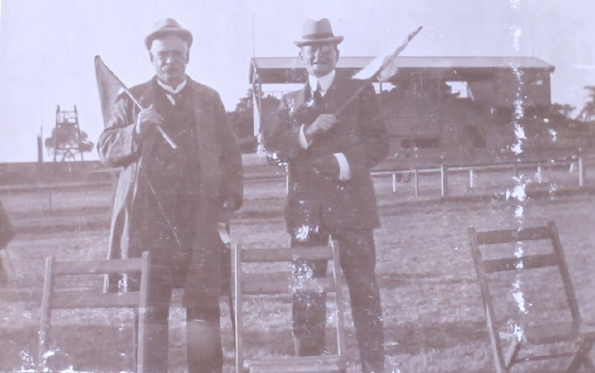 Two unidentified men holding flags