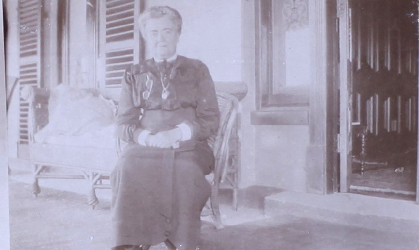 Unidentified woman sitting on a verandah