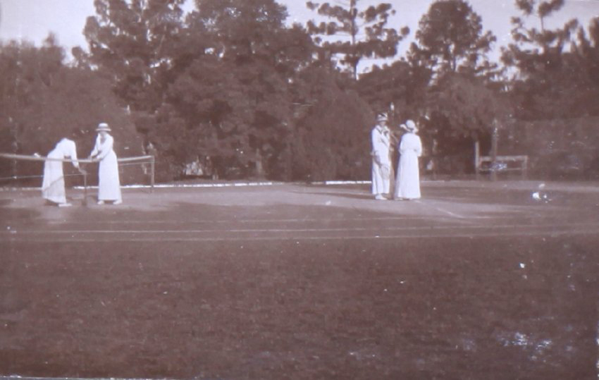 Four unidentified women on a tennis court