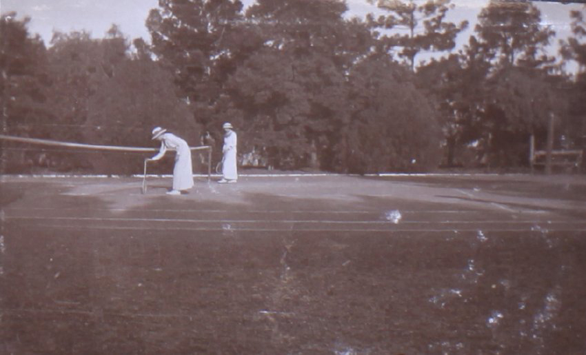 Two unidentified women on a tennis court