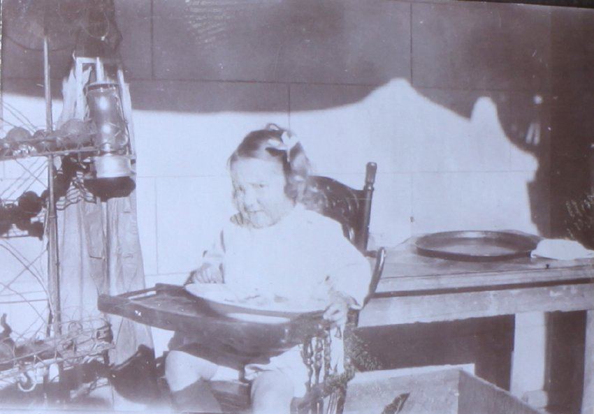Unidentified child in a high chair