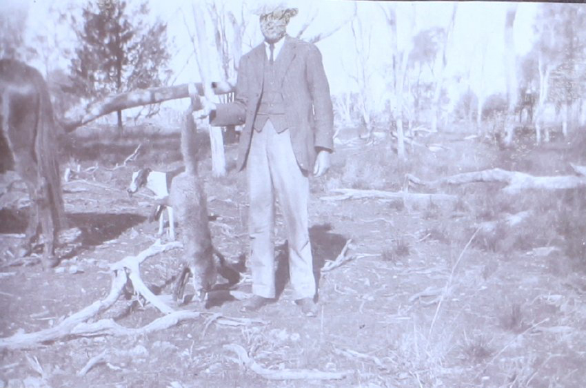 Unidentified man with a dead fox