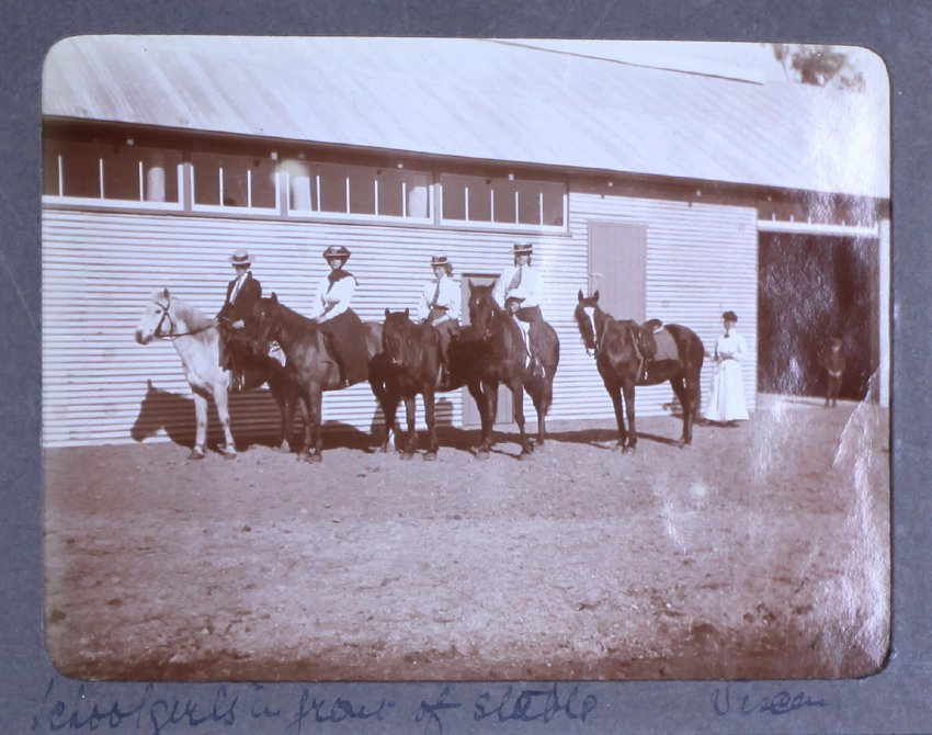 Schoolgirls in front of stable