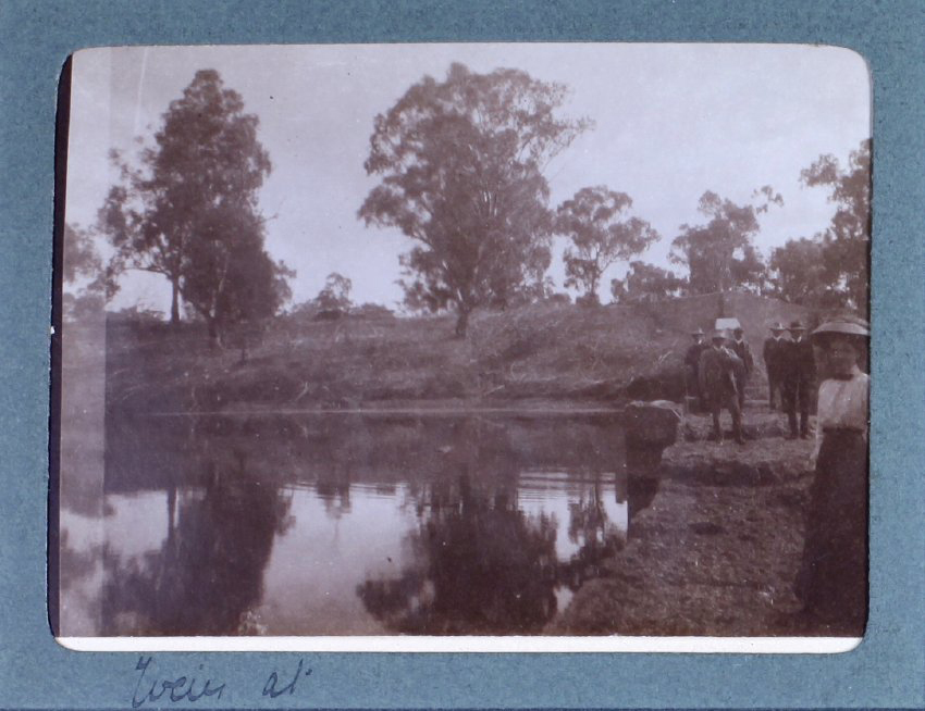 Unidentified woman beside a dam [?]