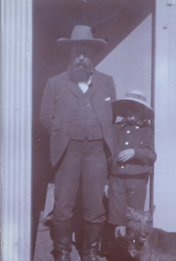 Unidentified man and boy with pet dog