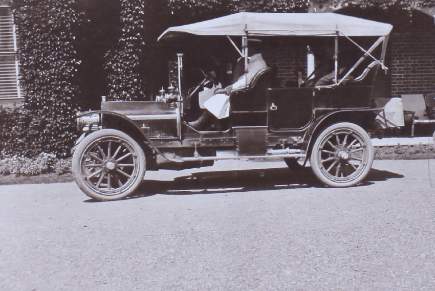 Unidentified people in a car at the front of a building