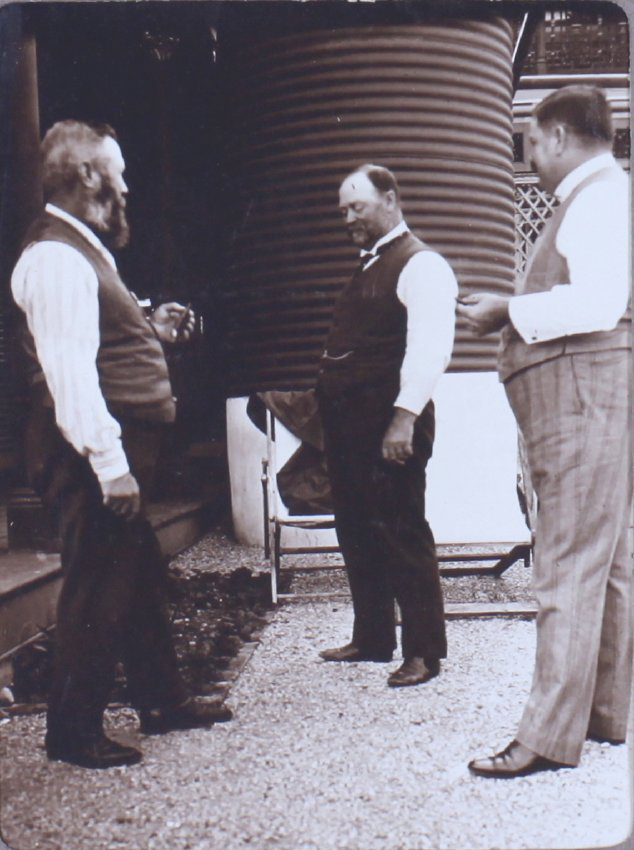 Three unidentified men near a tankstand