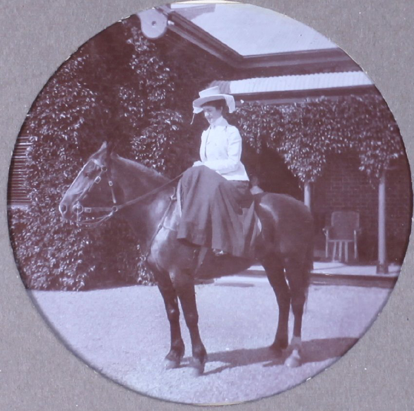 Unidentified woman on a horse riding sidesaddle
