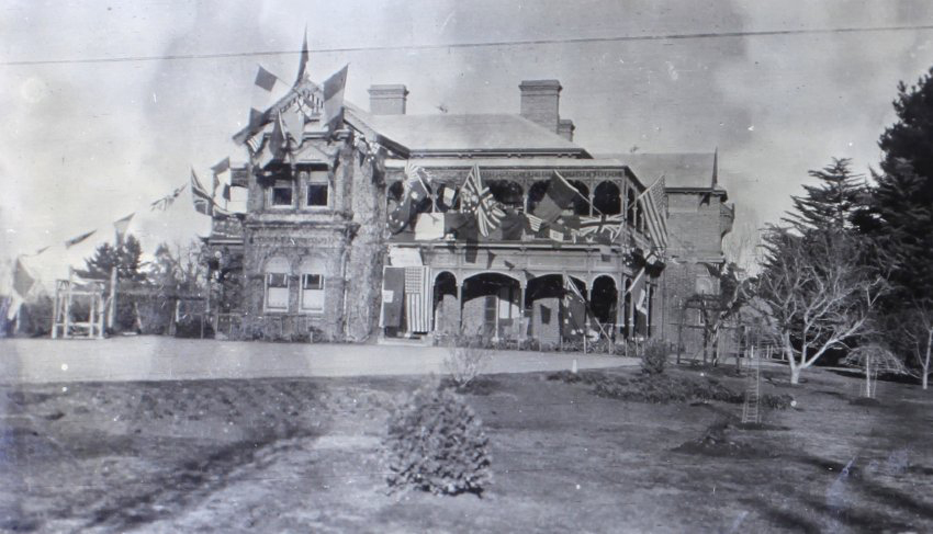 View of Saumarez Homestead covered with international flags