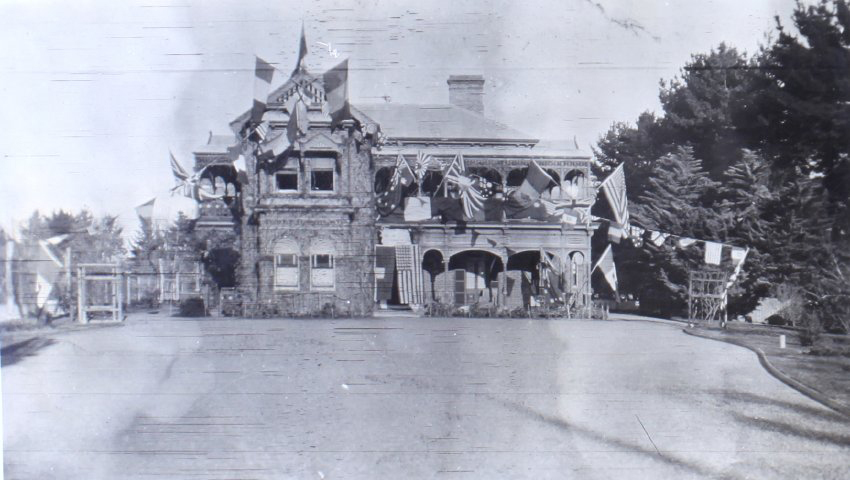 View of Saumarez Homestead covered with international flags