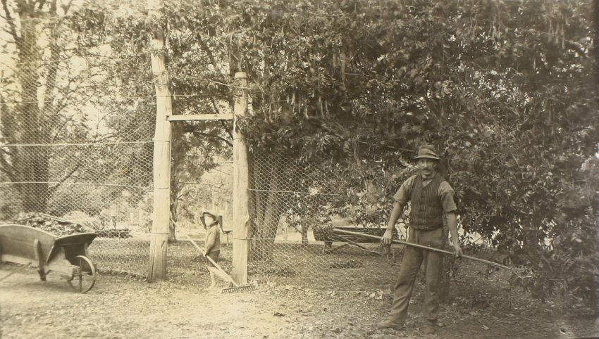 Unidentified man and young boy working in the gardens