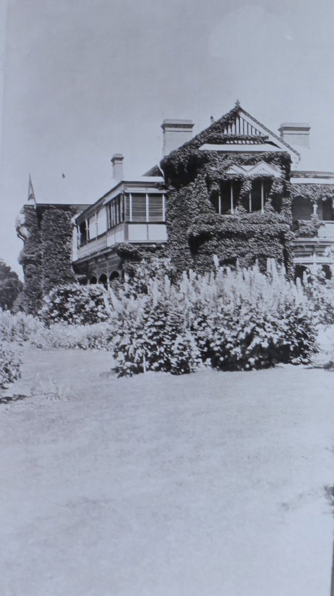 View of gardens with the homestead in the background