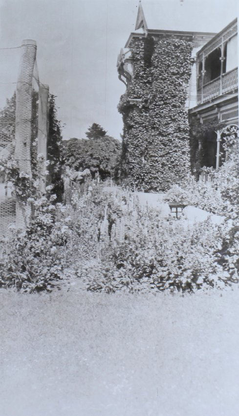 View of gardens with the homestead in the background