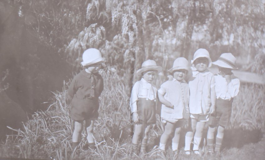 Group of five unidentified children in the garden
