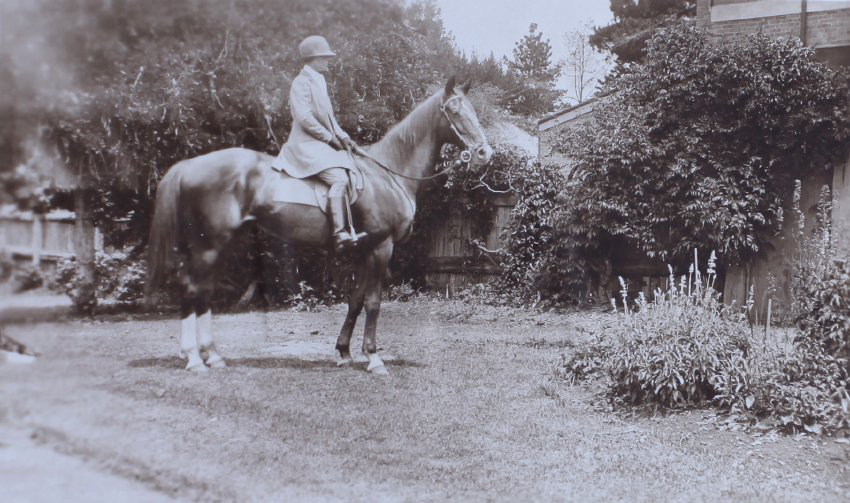 Unidentified woman on a horse in the gardens