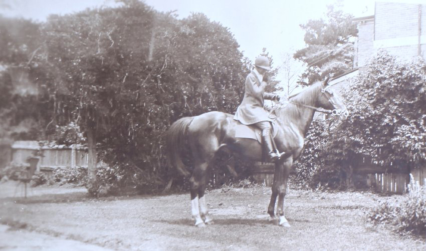 Unidentified woman on a horse in the gardens