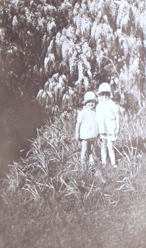 Two unidentified children in the garden