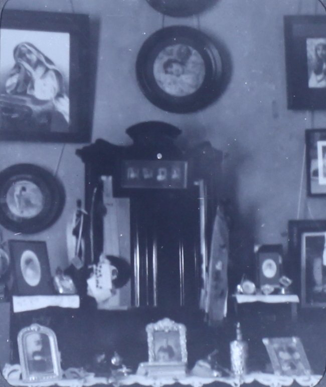 Interior photo showing pictures on wall and furniture