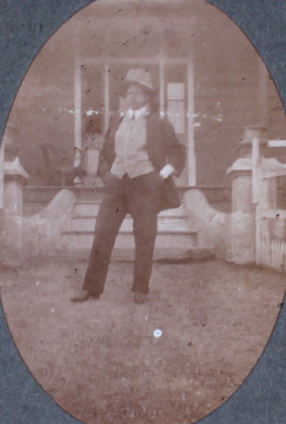 Unidentified man in front of a house