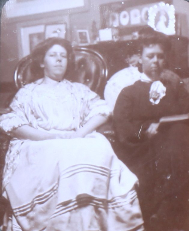 Two unidentified women sitting in the house
