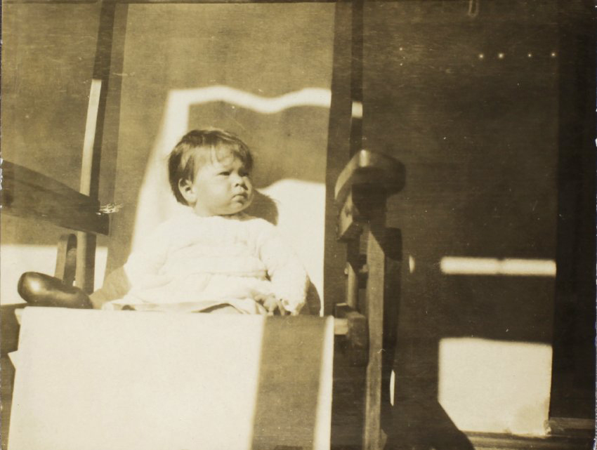 Small child sitting in a chair