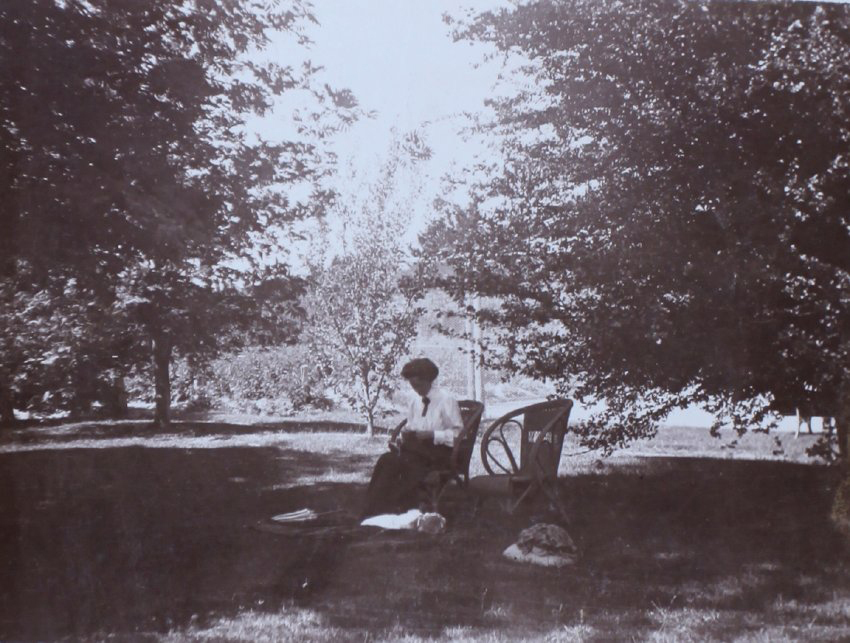Unidentified woman sitting in the gardens
