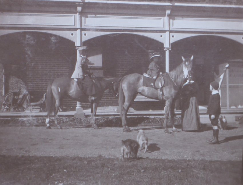 Unidentified woman and child on horseback
