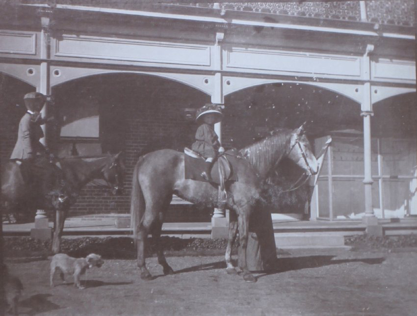 Unidentified woman and child on horseback