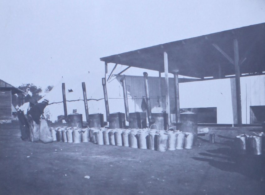 Unidentified men with large buckets and furnaces