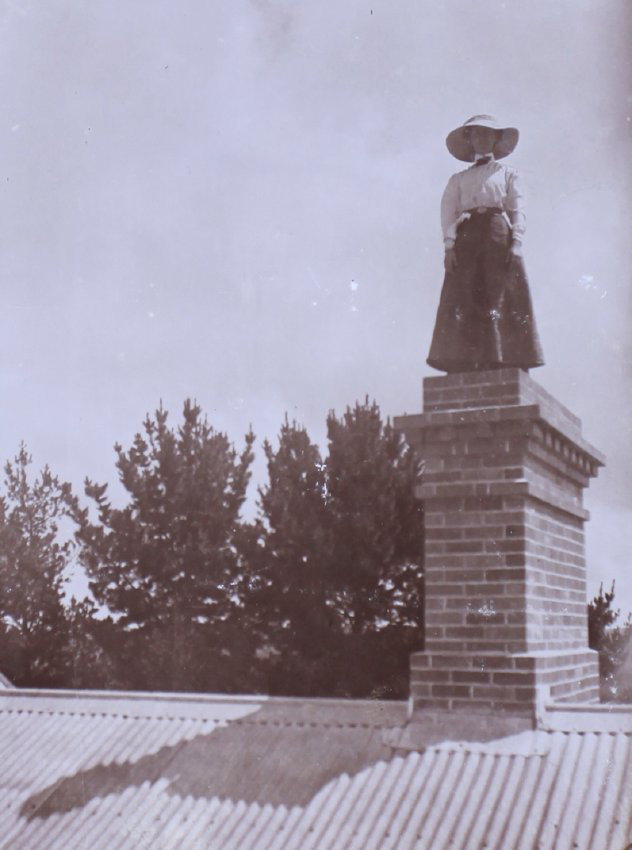 Unidentified woman standing on top of a chimney