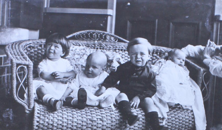 Four unidentified children on a lounge
