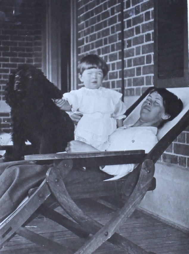 Unidentified woman and child with a pet dog