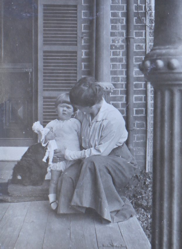 Unidentified woman and child with a pet dog