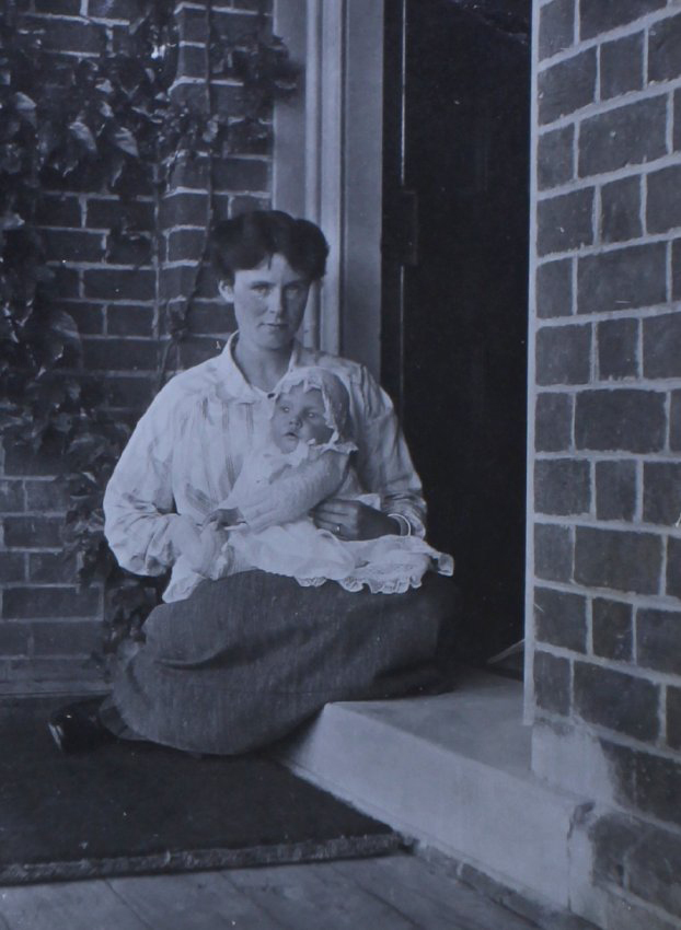 Unidentified woman cradling a baby